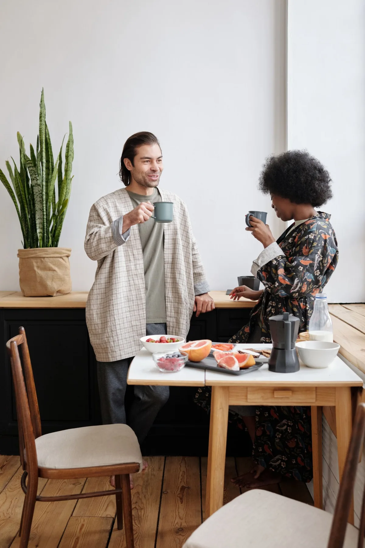 Happy couple sharing a sunlit breakfast together at home, warm and hopeful